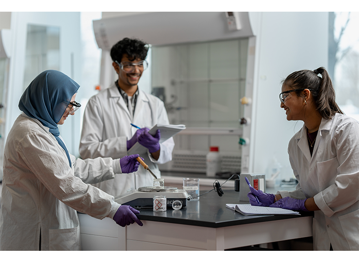 Media Bank image of three scientists in PPE