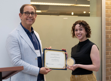 Department Chair Mark Lautens presents a medal to Dr. Alicia Battaglia
