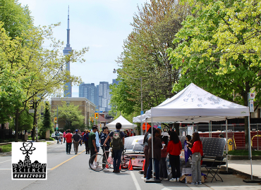 Festival-style gathering in front of CN Tower
