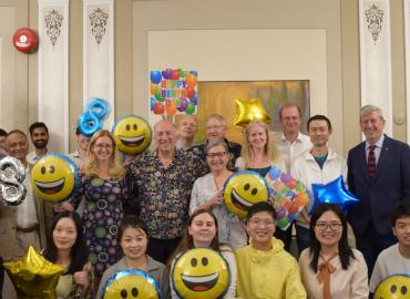 Photo of Prof. Geoff Ozin&amp;#039;s posing with students, staff, and co-workers. They are holding balloons and signs saying &amp;quot;Happy Birthday&amp;quot;